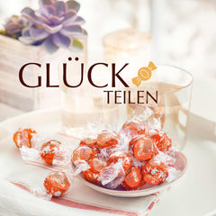 Lindt LINDOR Vörös narancssárga csokoládégolyók | 1 kg-os visszazárható zacskó | kb. 80 db csokoládé cukorka szájban olvadó töltelékkel | Tömeges csomag, csokoládé ajándék